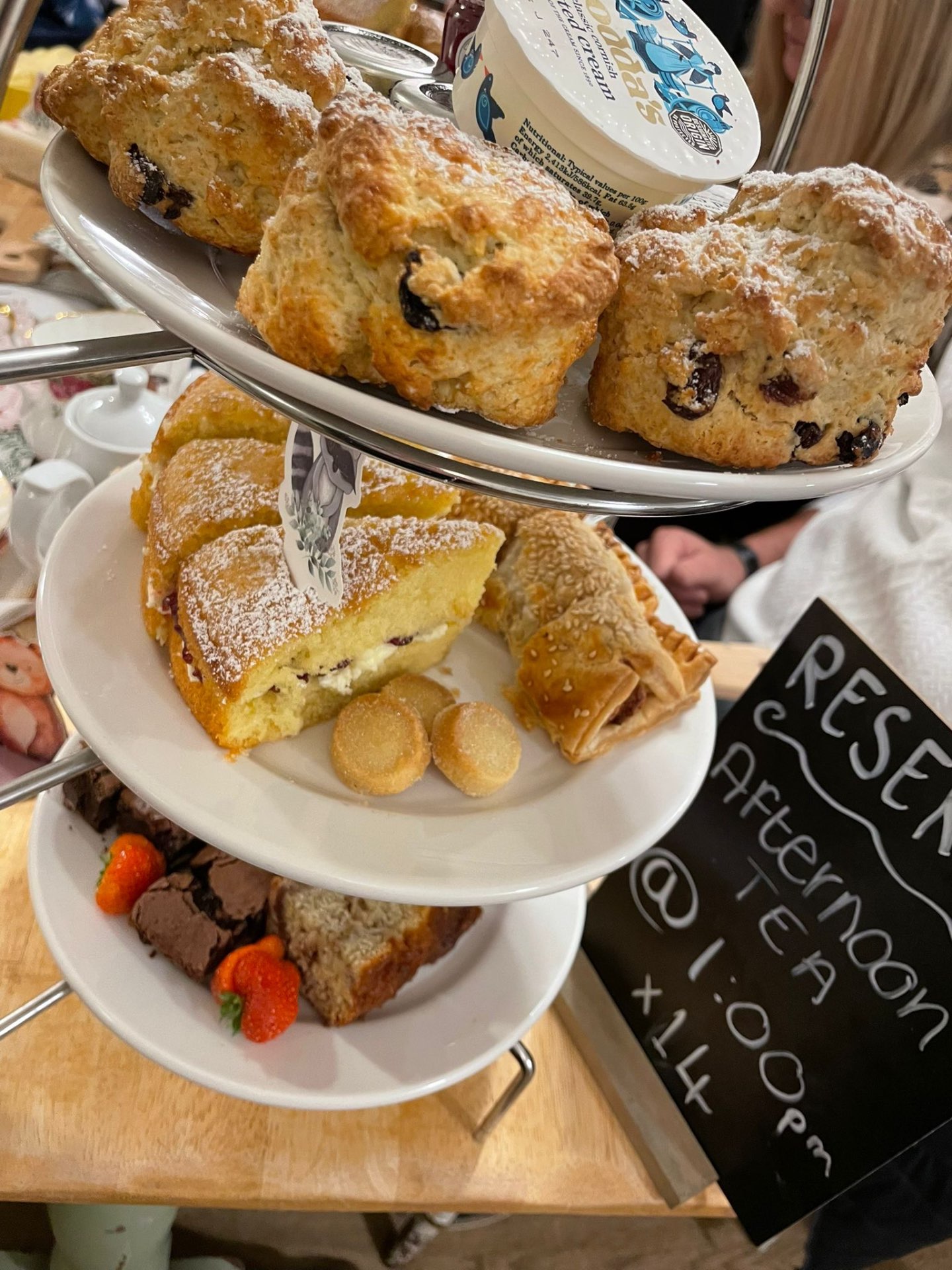 Tiered afternoon tea stand with cakes and scones