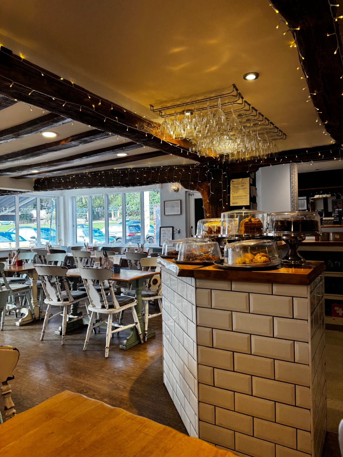 Interior dining space at Winners with wooden beams, tables and cake counter