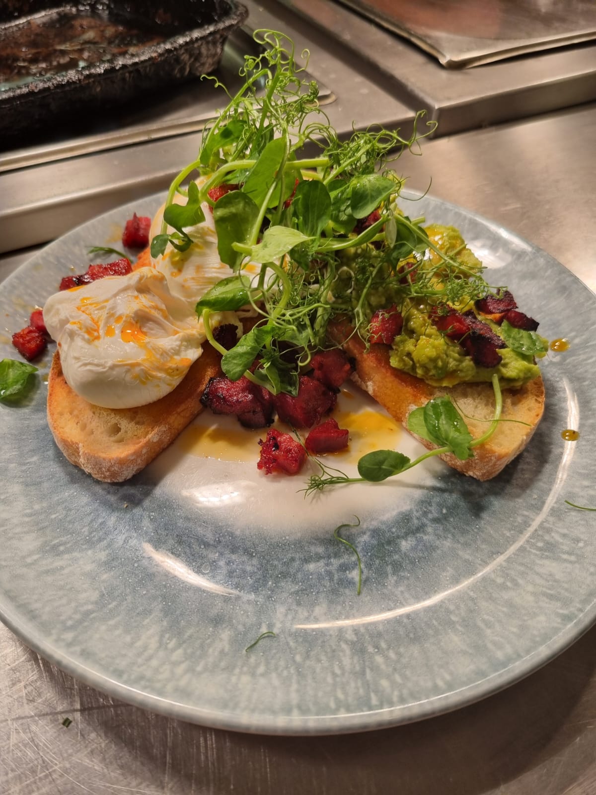 Poached eggs, smashed avocado and chorizo on toasted sourdough